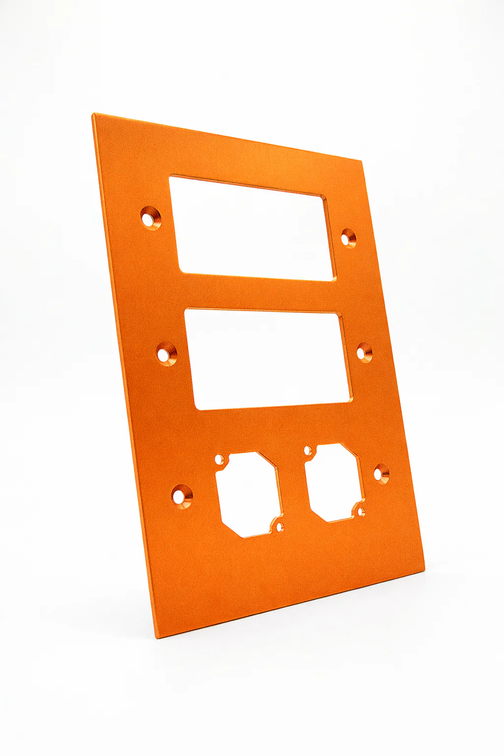 Orange anodized aluminum control panel with rectangular cutouts