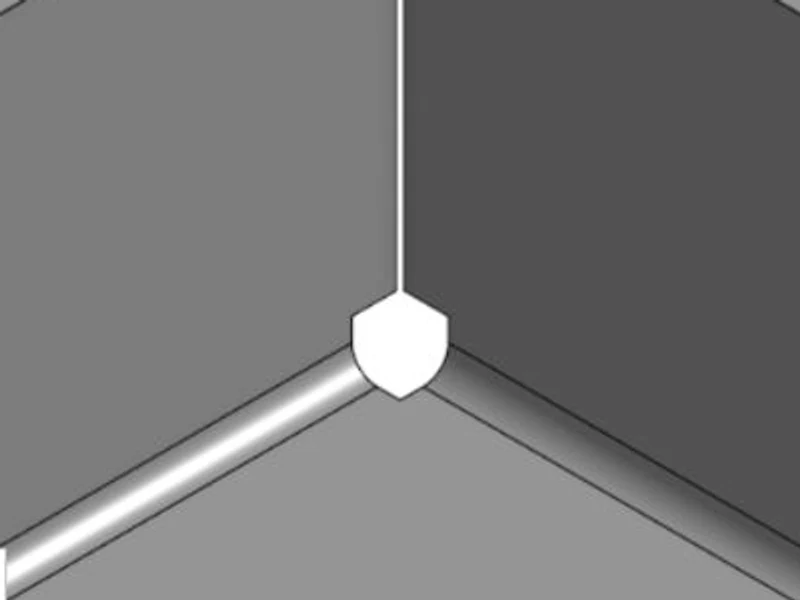 Formed box corner with a square sized corner relief: a small shield-shaped opening where the two walls meet the floor