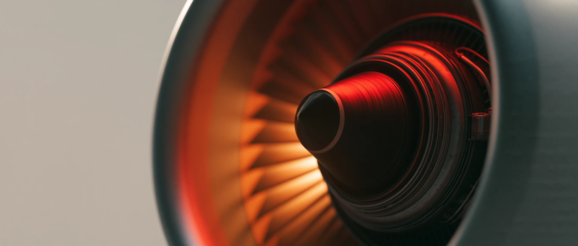 Close view of a turbine with red and orange light across its central hub and blades
