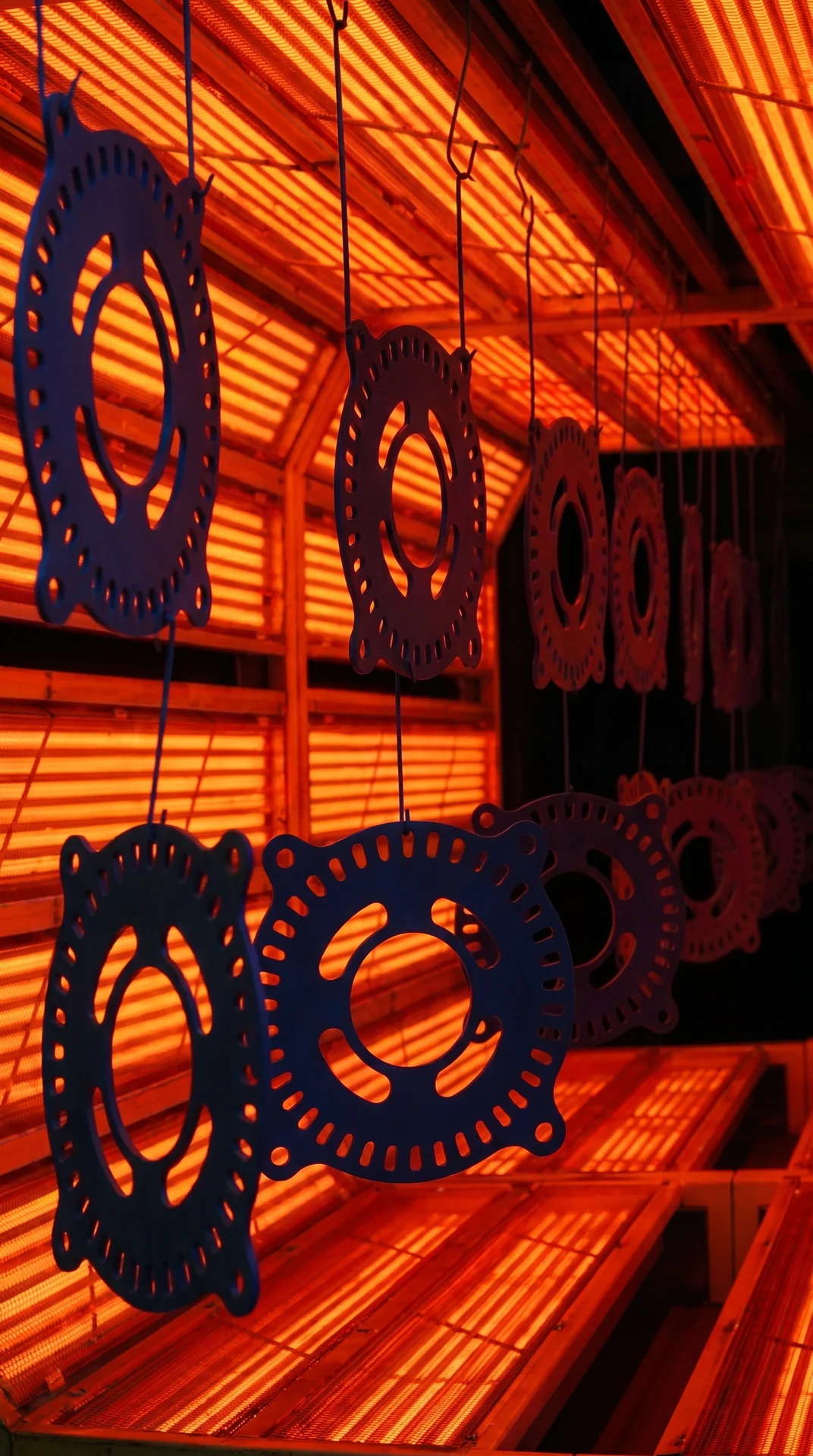 Hanging metal parts inside a powder-coating curing oven