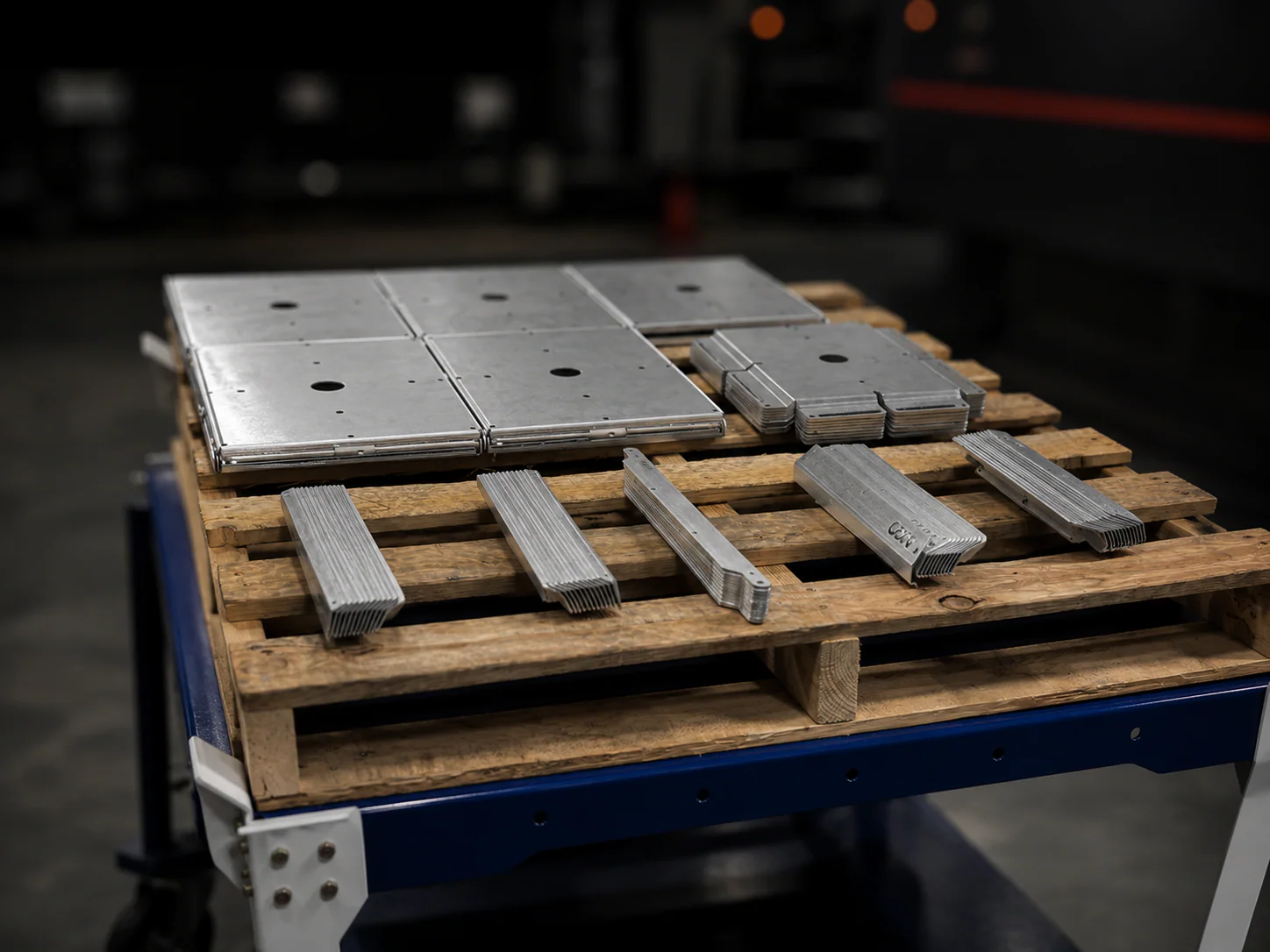 Small validation batch of formed sheet metal parts on a pallet
