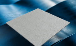 A textured gray metal sheet floating above a rippled, reflective blue surface under soft lighting.